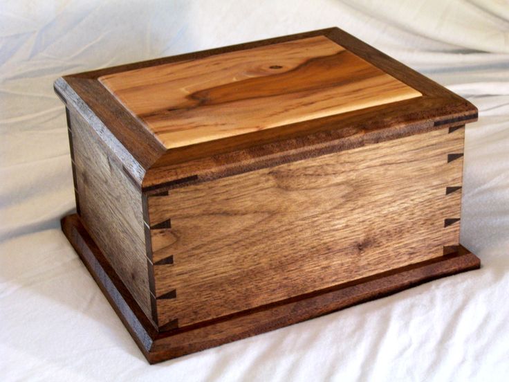 a wooden box sitting on top of a white sheet