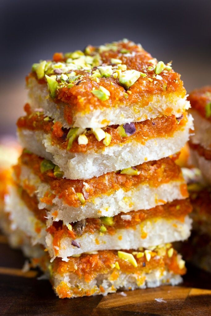 several pieces of food stacked on top of each other with pistachio toppings