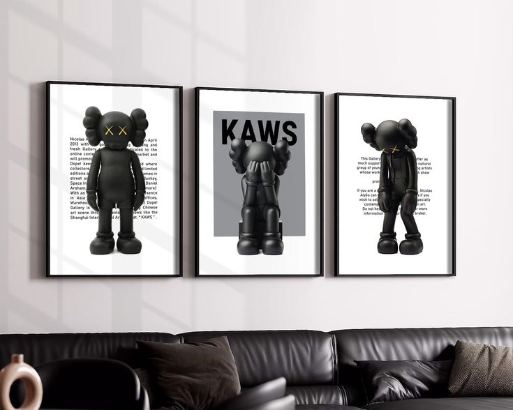 three black and white posters on the wall above a couch