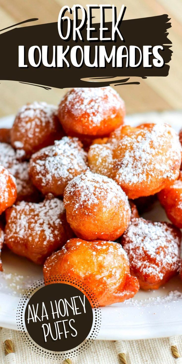 a white plate topped with powdered sugar covered donuts