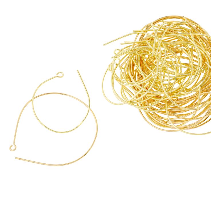 a bunch of yellow rubber bands sitting on top of a white table next to a pair of scissors