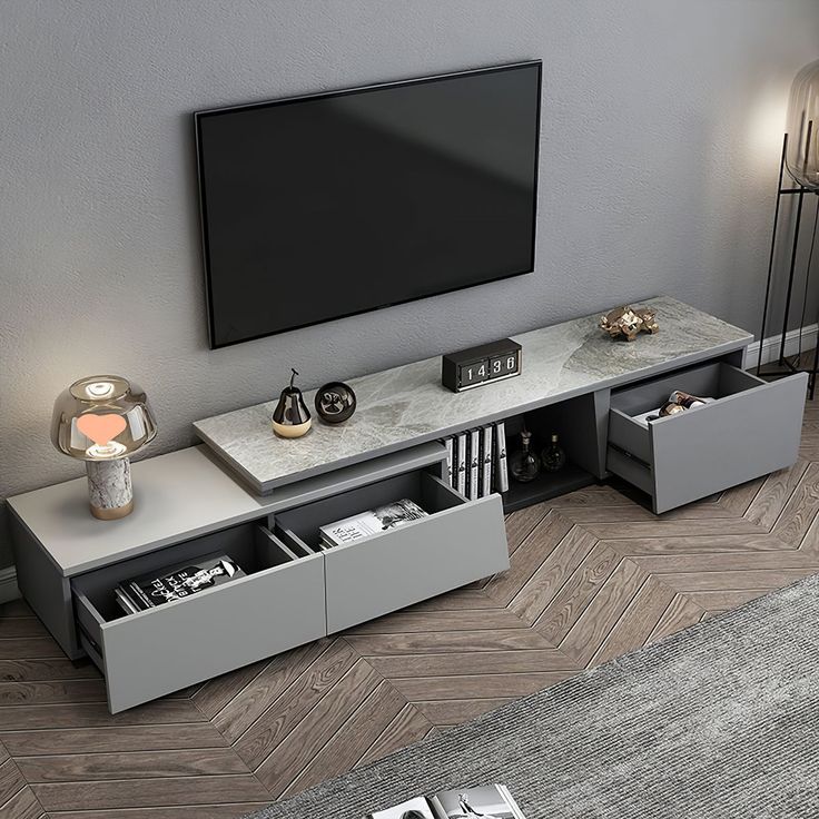 an entertainment center with two drawers and a flat screen tv mounted on the wall