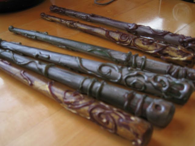 four decorative wooden canes sitting on top of a table