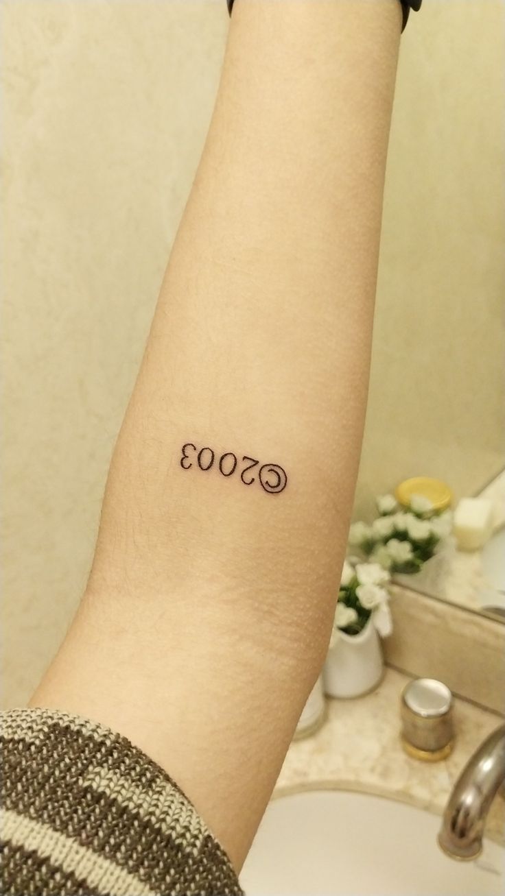 a person with a small tattoo on their arm