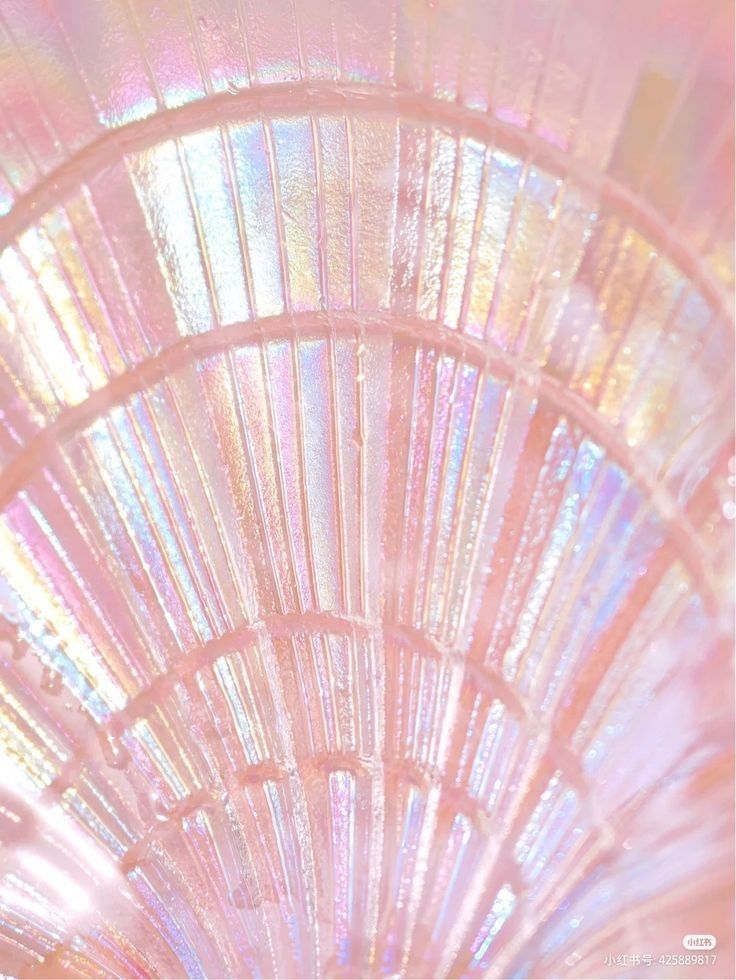 a close up view of the inside of a glass vase with iridescent colors