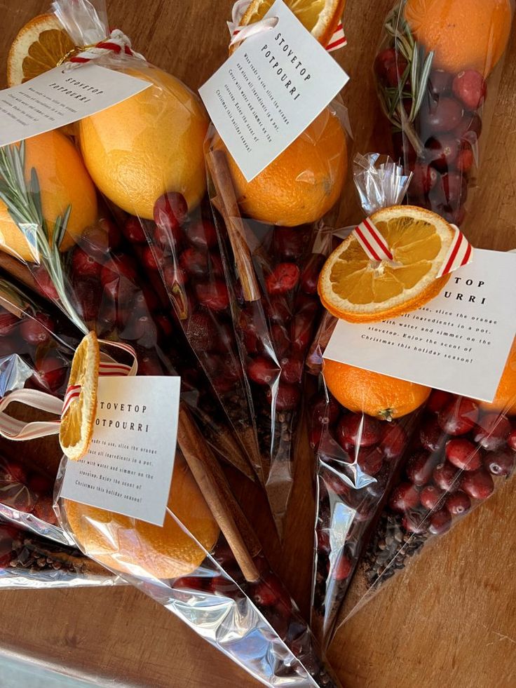 oranges and cranberries wrapped in cellophane with labels on them sitting on a table