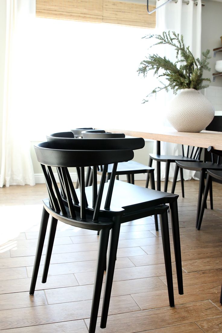 a dining room table with four chairs around it