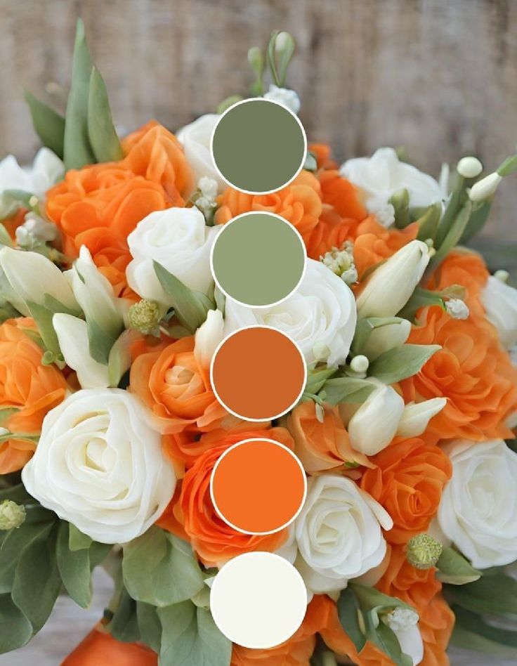 an orange and white bridal bouquet with greenery, tulips and roses