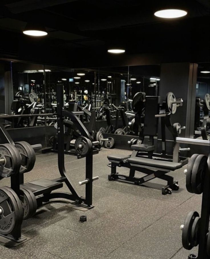 an empty gym with rows of weight machines