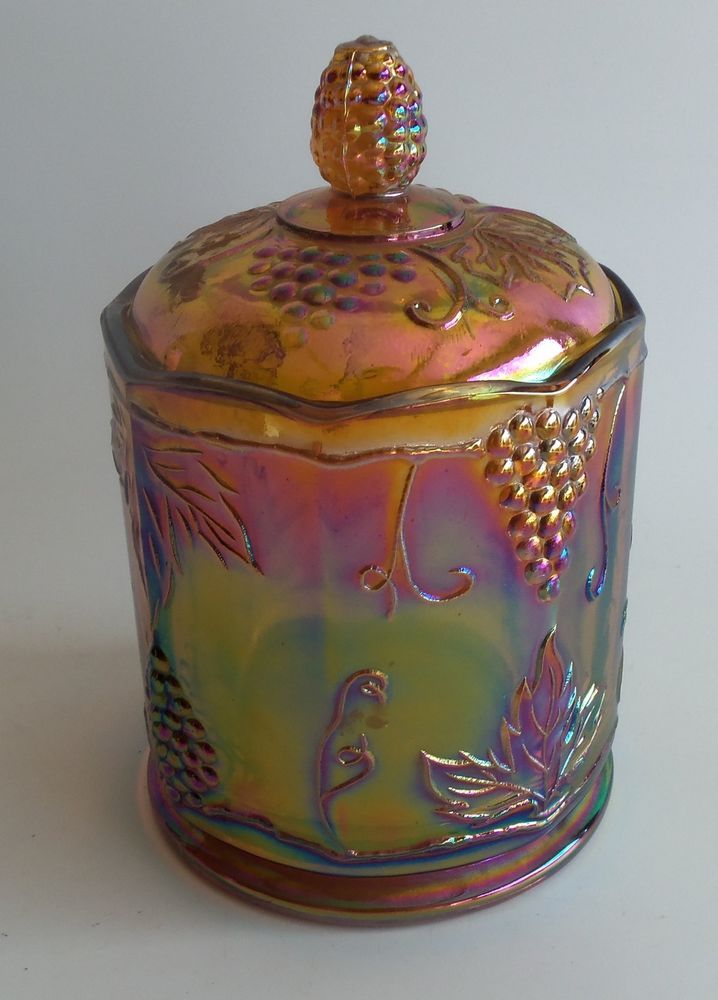 a colorful glass jar with a gold top