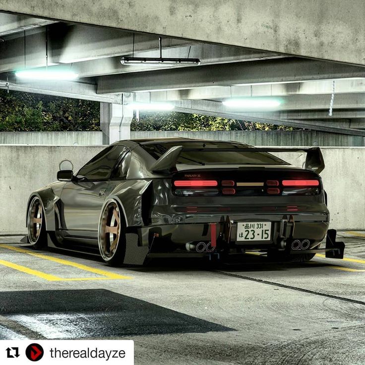 a black sports car parked in a parking garage