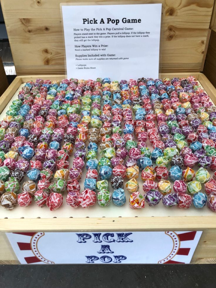 a display case filled with lots of different colored diced items on top of a wooden table