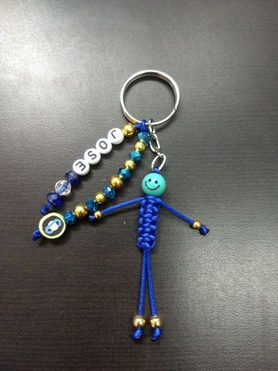 a blue beaded keychain with a smiley face on it