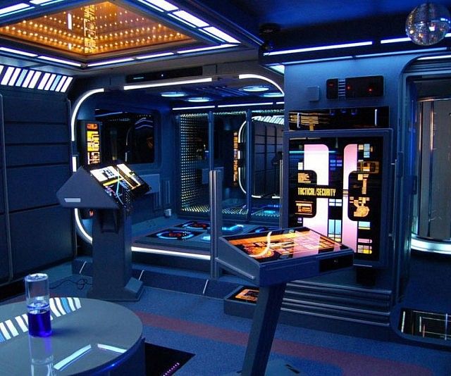 the interior of a sci - fi themed restaurant with tables, chairs and televisions