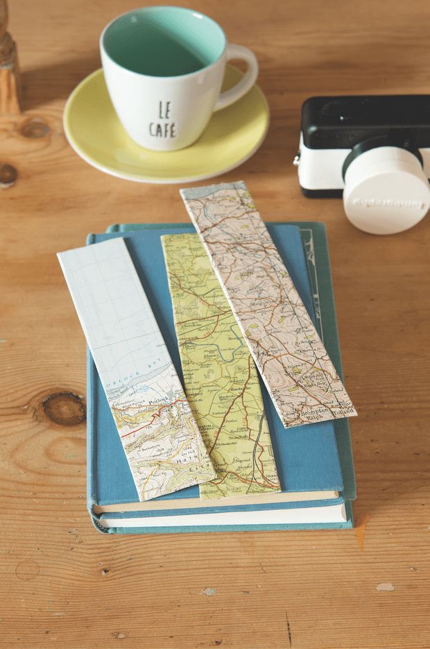 a map, coffee cup and cell phone on a table