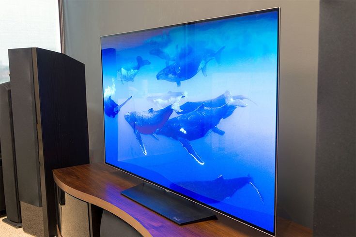 a flat screen tv sitting on top of a wooden stand