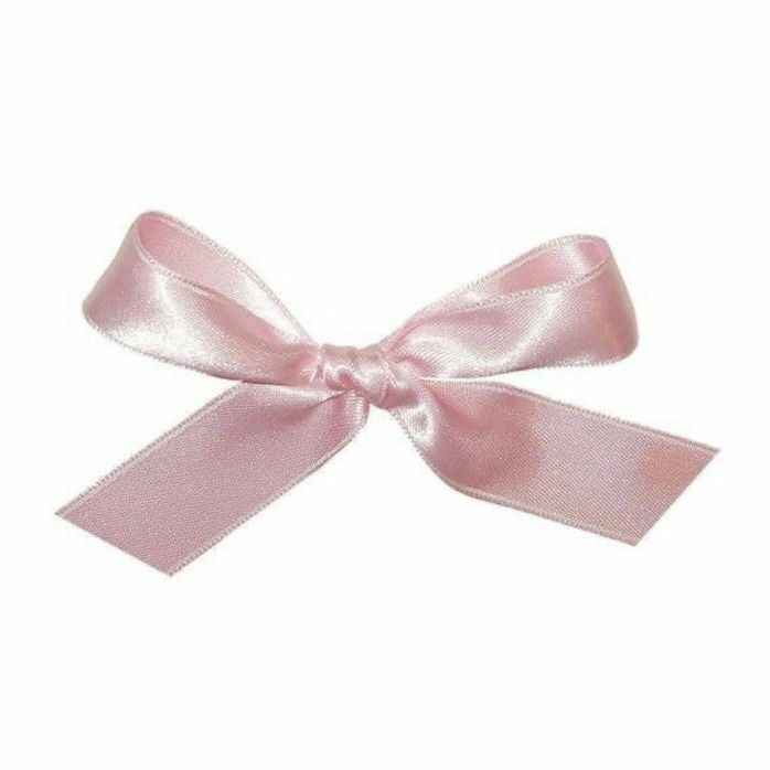 a pink ribbon tied to the side of a white wall with a bow on it