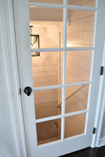 an open door leading into a room with white walls