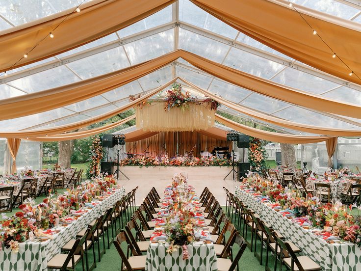 a large tent with tables and chairs set up for a wedding or other function in it