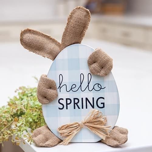 a wooden sign that says hello spring on it