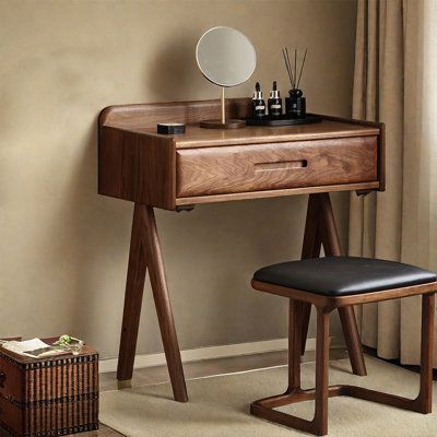 a wooden desk with a mirror and stool