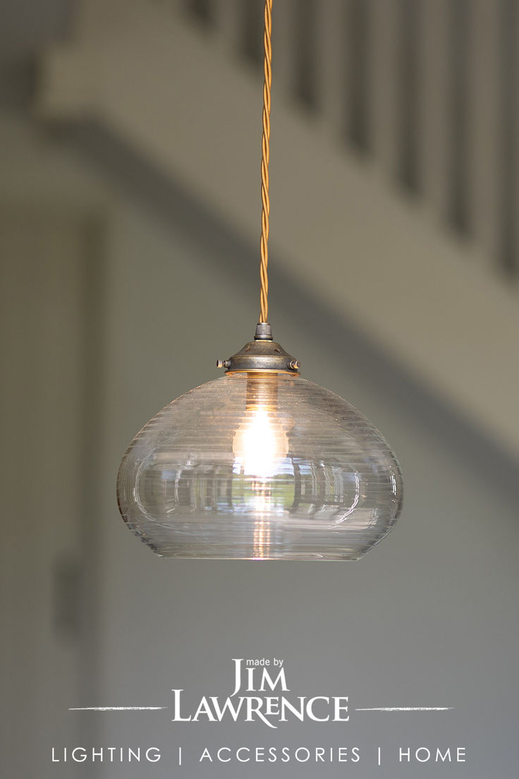 a glass light hanging from a ceiling in a house with the words j m lawrence lighting accessories