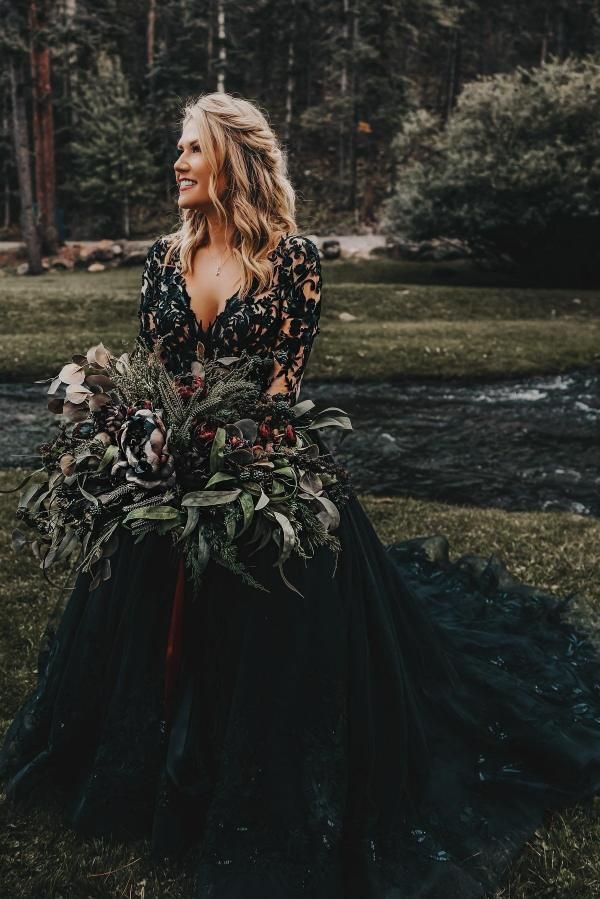 a woman in a black dress holding a bouquet