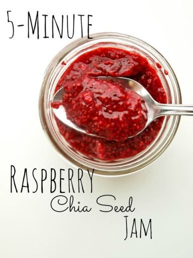 raspberry chia seed jam in a glass jar with spoon on white background