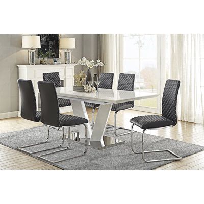 a dining room table with chairs and a rug