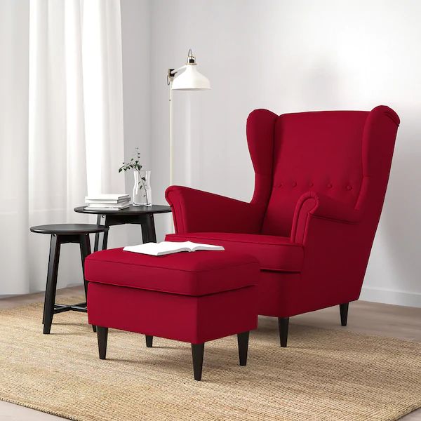 a red chair and ottoman in a living room