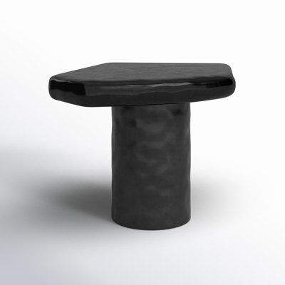 a small black table sitting on top of a white floor