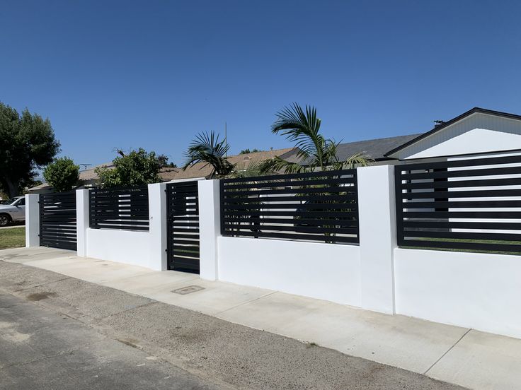 a white fence with black slats on it