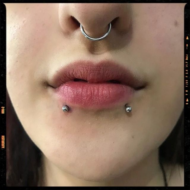 a woman with piercings on her nose