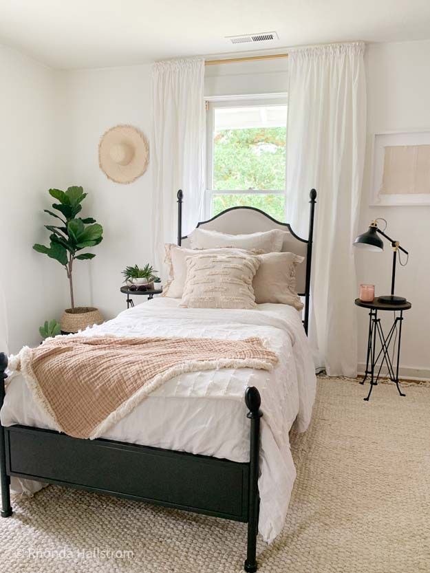 a bedroom with white walls and neutral decor