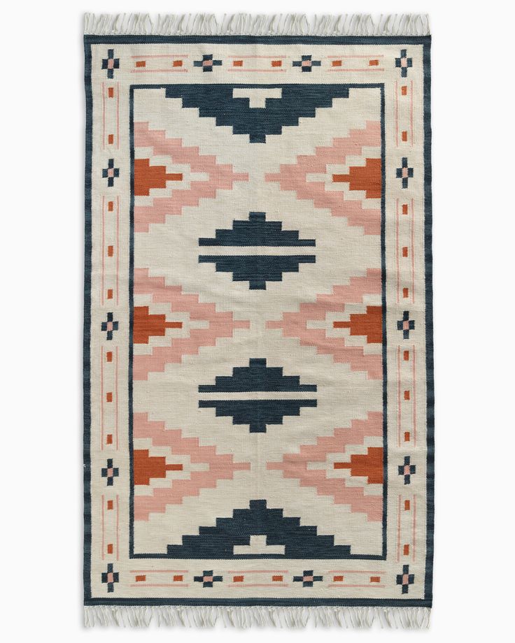 a rug with an orange, blue and white design on the bottom half of it