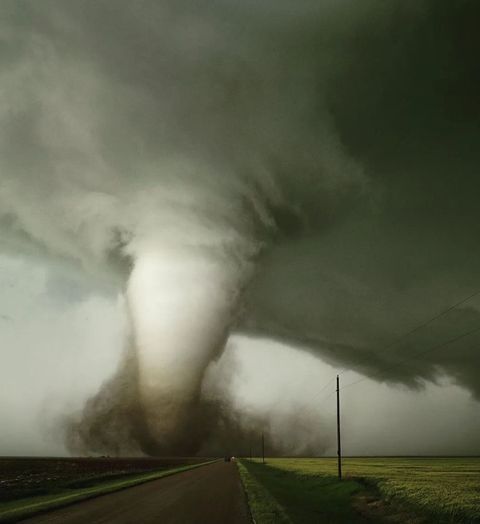 a large tornado is coming down the road