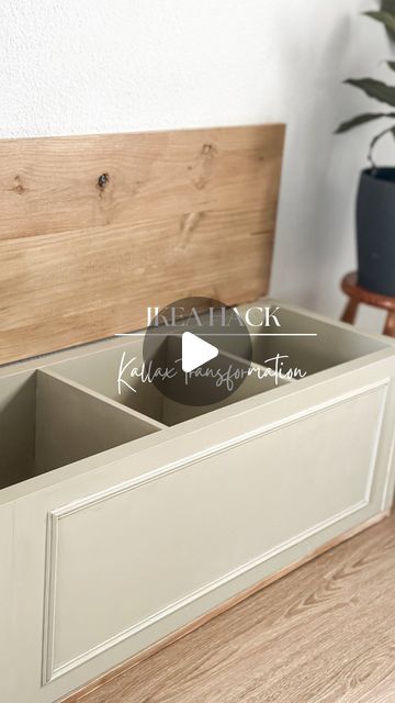 an open drawer on top of a wooden floor next to a planter and potted plant