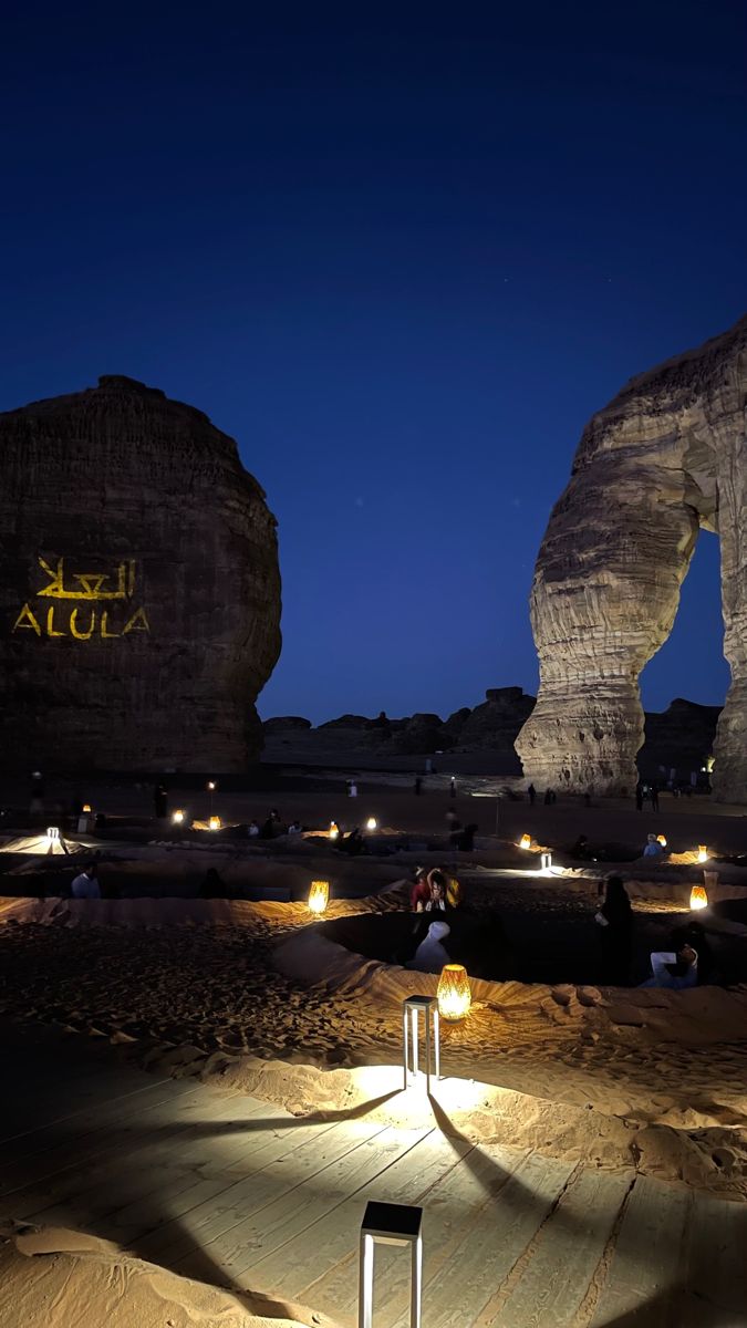 two large rock formations lit up at night