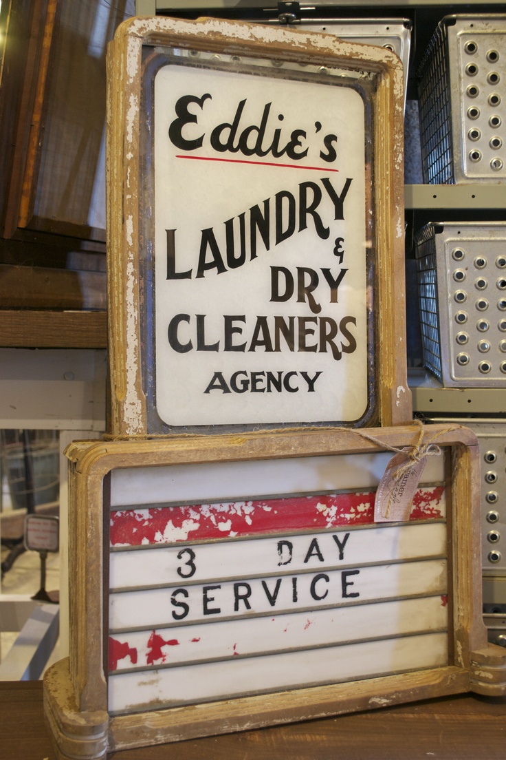 an old sign advertising laundry and dry cleaners