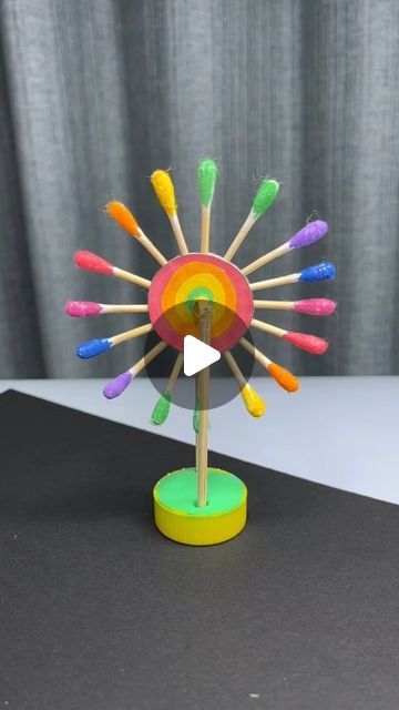 a colorful spinning toy on top of a black table