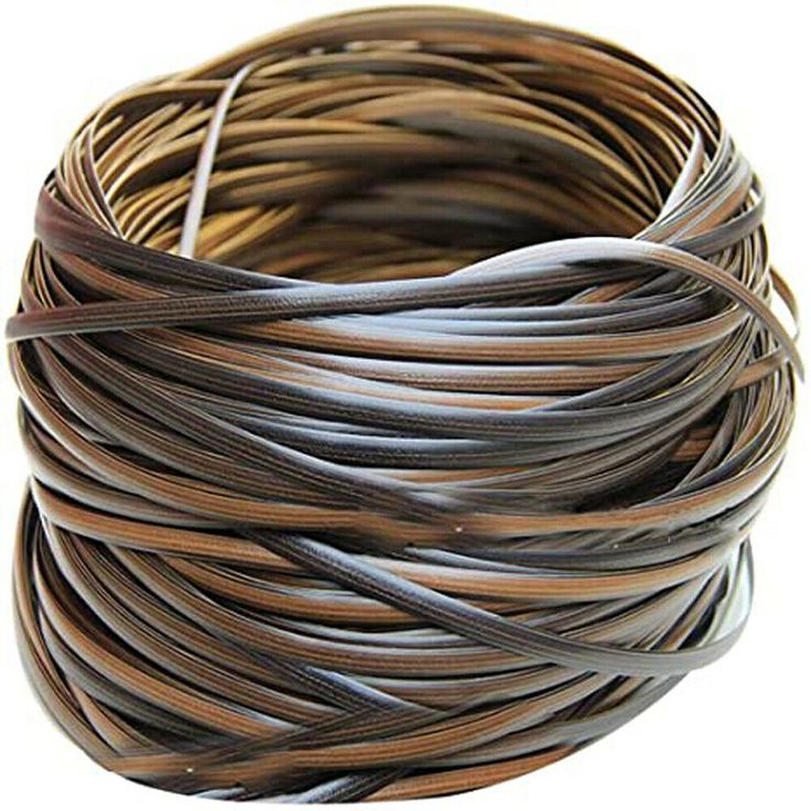 a coil of brown and black wire on a white surface