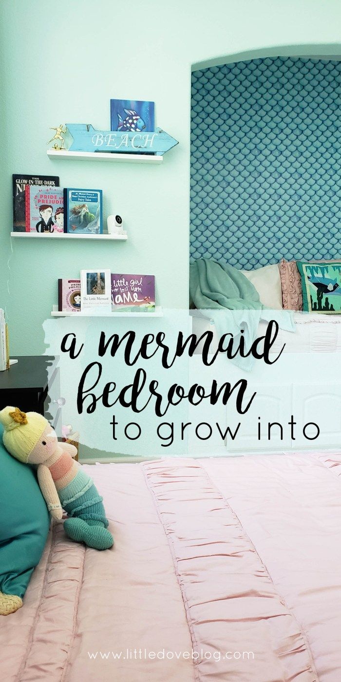 a mermaid bedroom with pink bedding and green walls, along with a stuffed animal