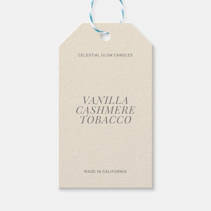 vanilla cashmere tobaco label with blue string on white paper tag that reads, celestial glow candles vanilla cashmere tobaco made in california