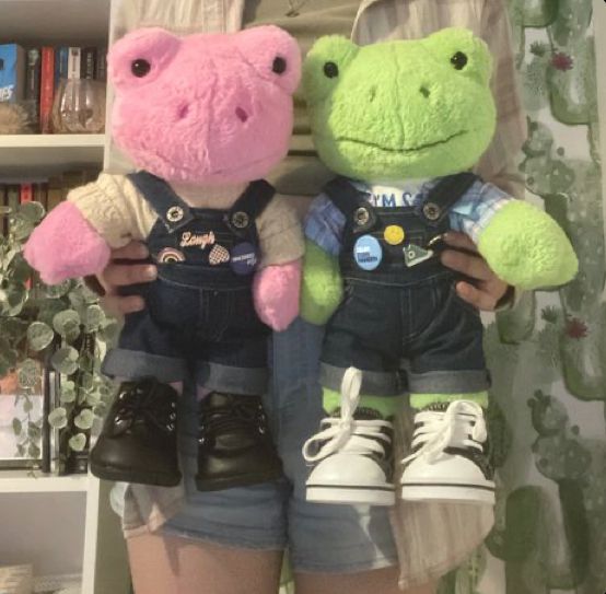 two stuffed animals are standing next to each other