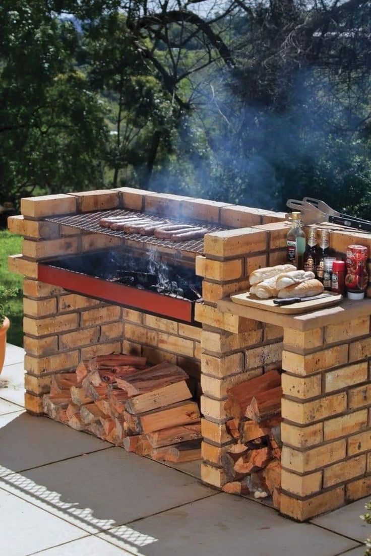 an outdoor bbq grill with lots of wood