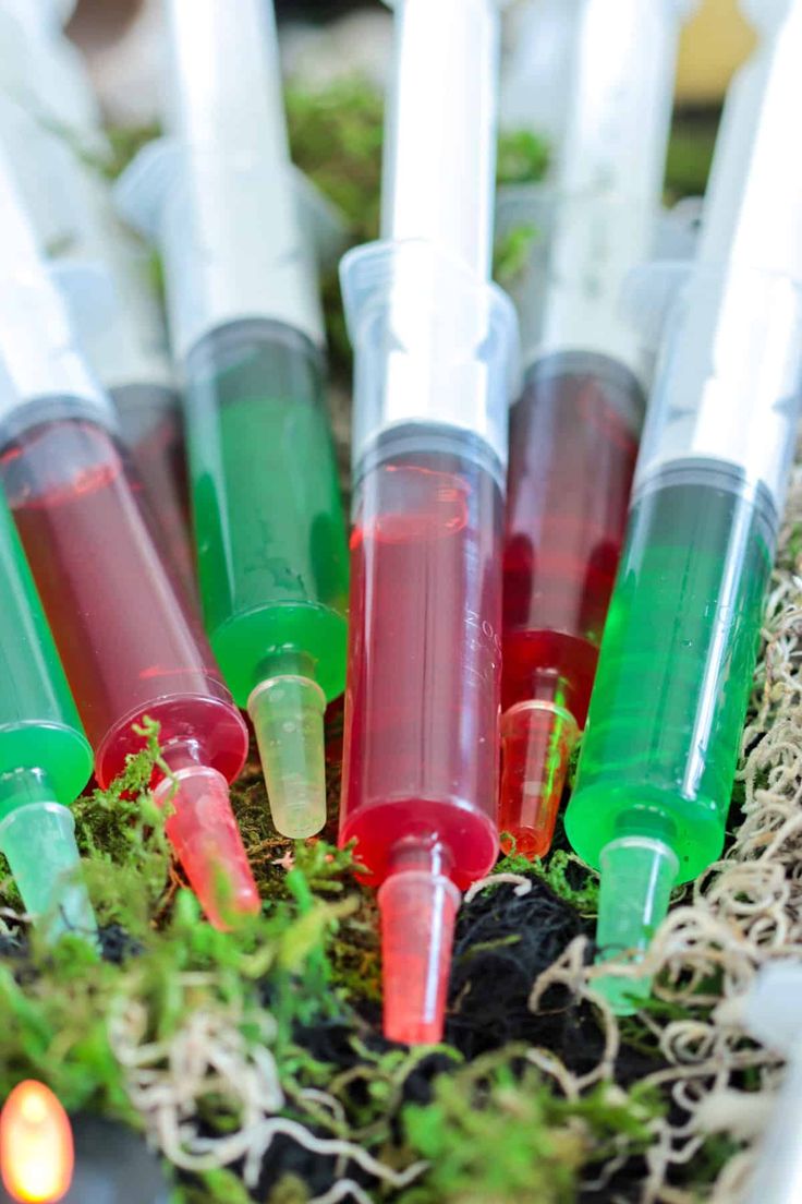 several tubes filled with liquid sitting in the grass