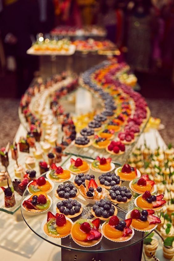 a table filled with lots of different types of cupcakes