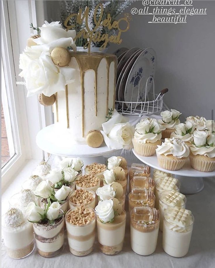 a table topped with lots of cupcakes and cakes