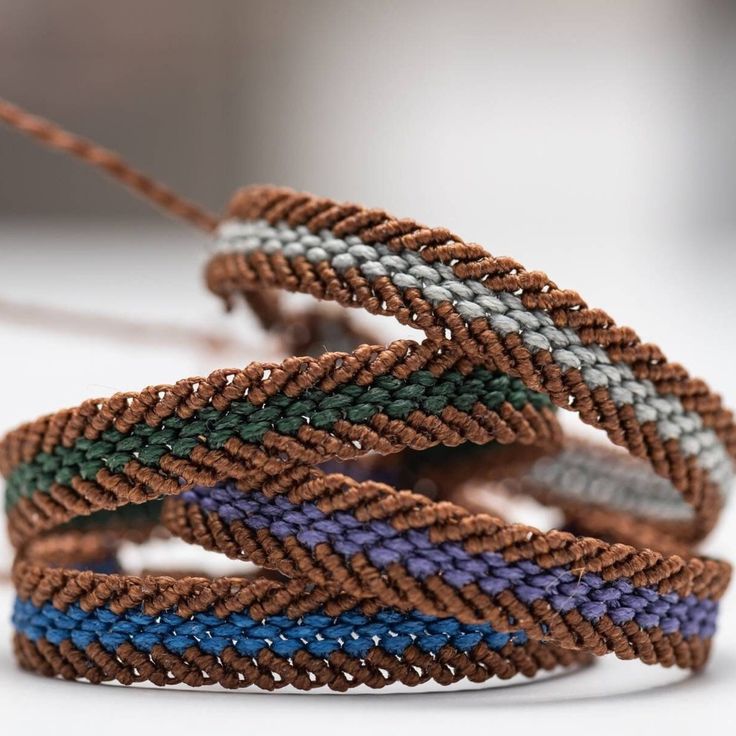 several different colored bracelets on a white surface