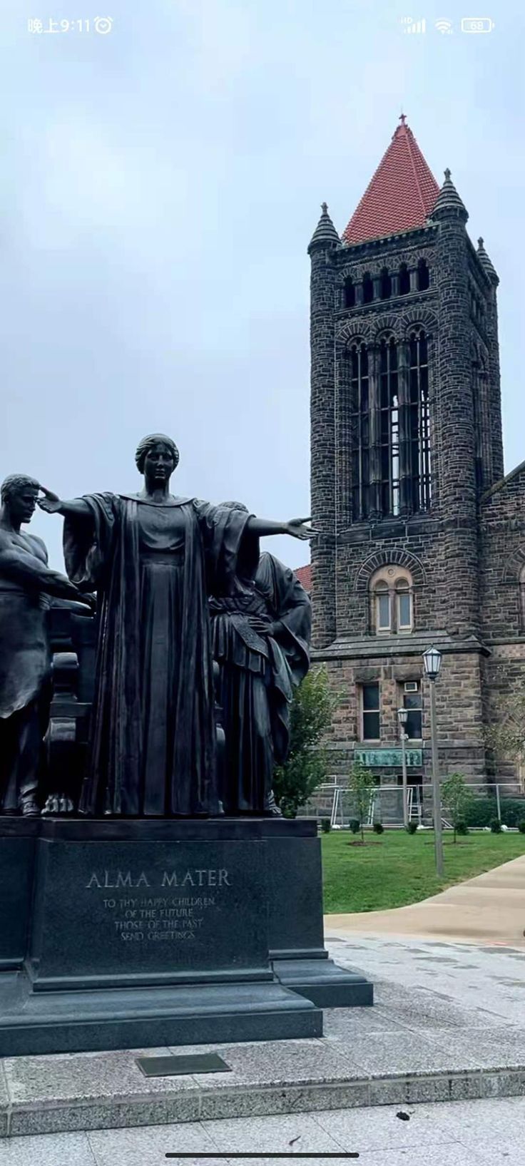 a statue in front of a building with a clock tower